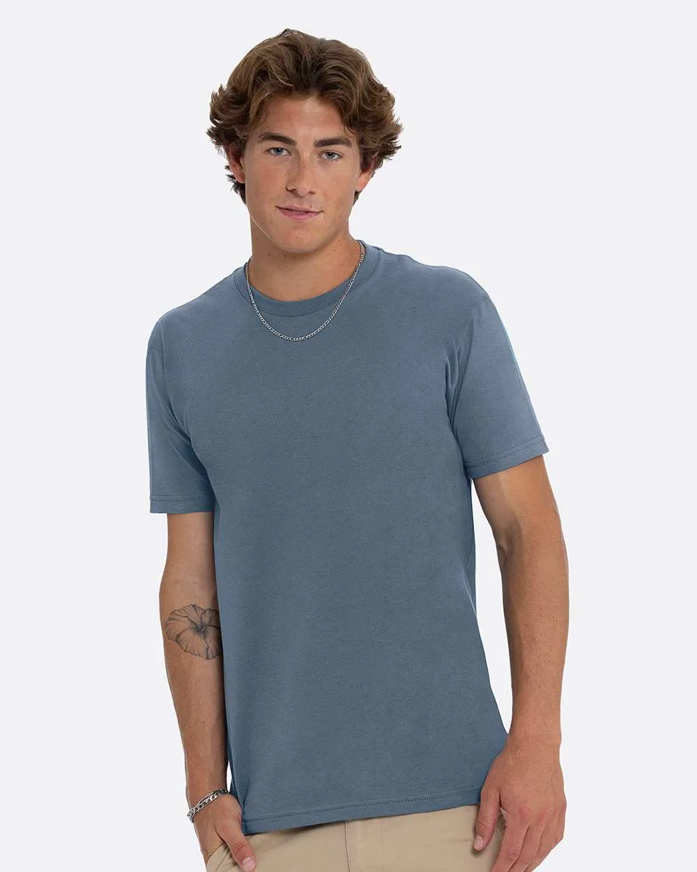 Model wearing a blue Next Level 3600 t-shirt