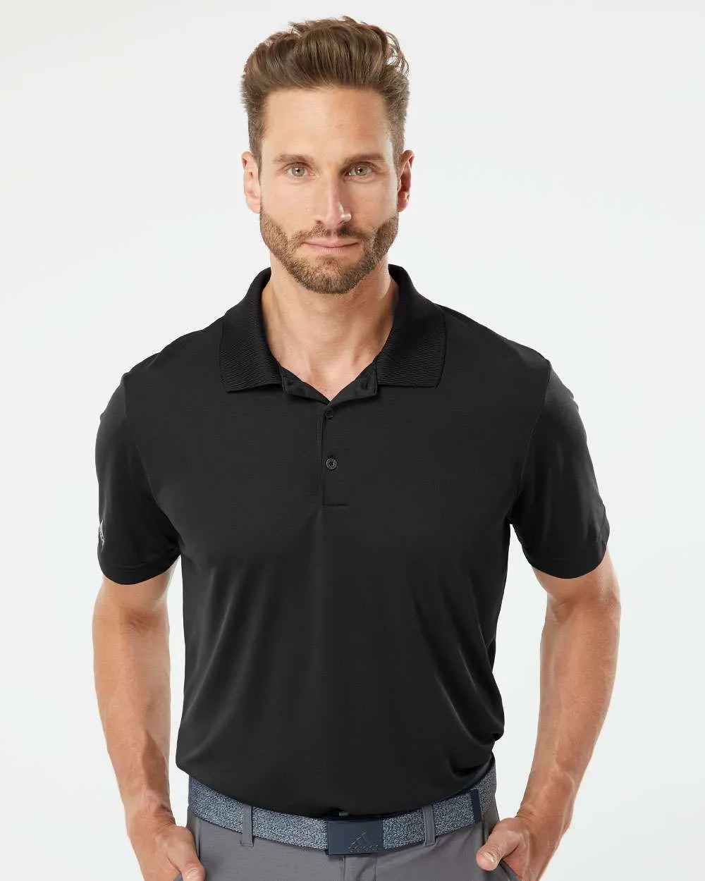 Model wearing a black adidas A230 performance polo